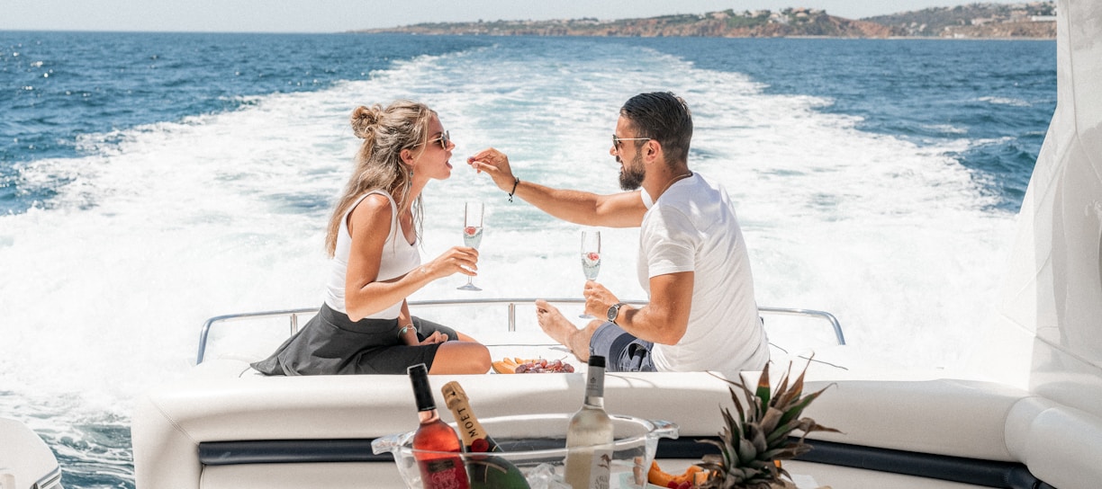 couple sitting on white boat during daytime