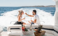 couple sitting on white boat during daytime
