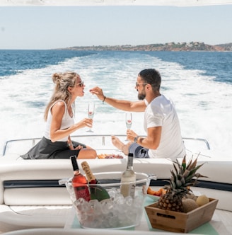 couple sitting on white boat during daytime