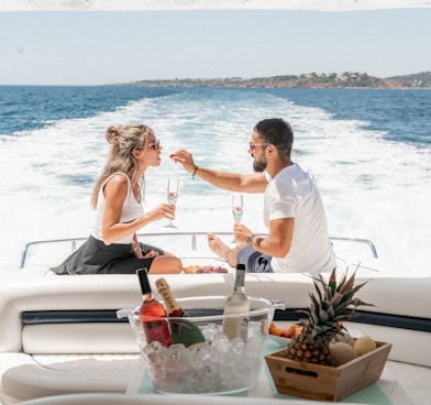 couple sitting on white boat during daytime