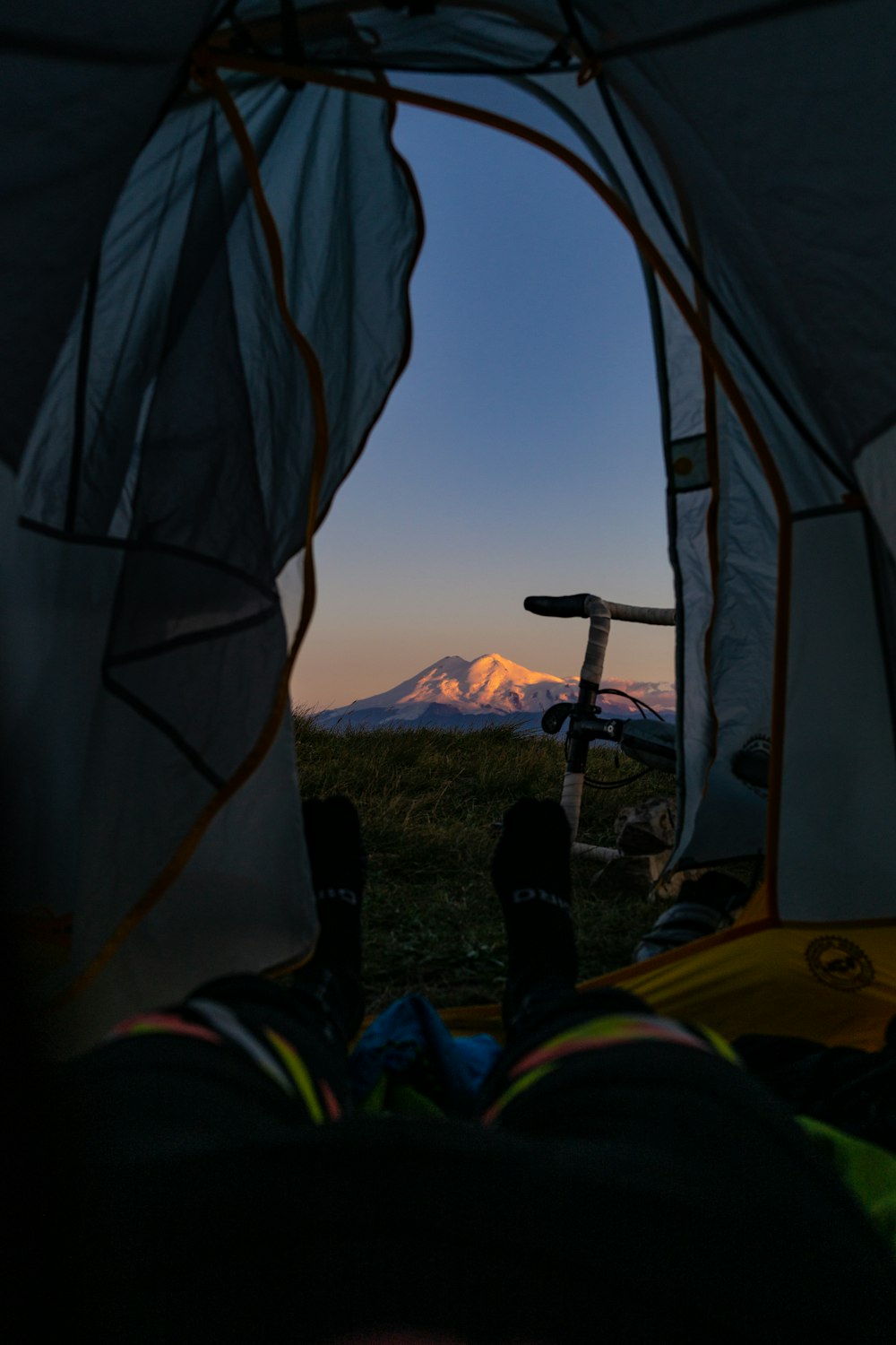 a view of a mountain from inside a tent