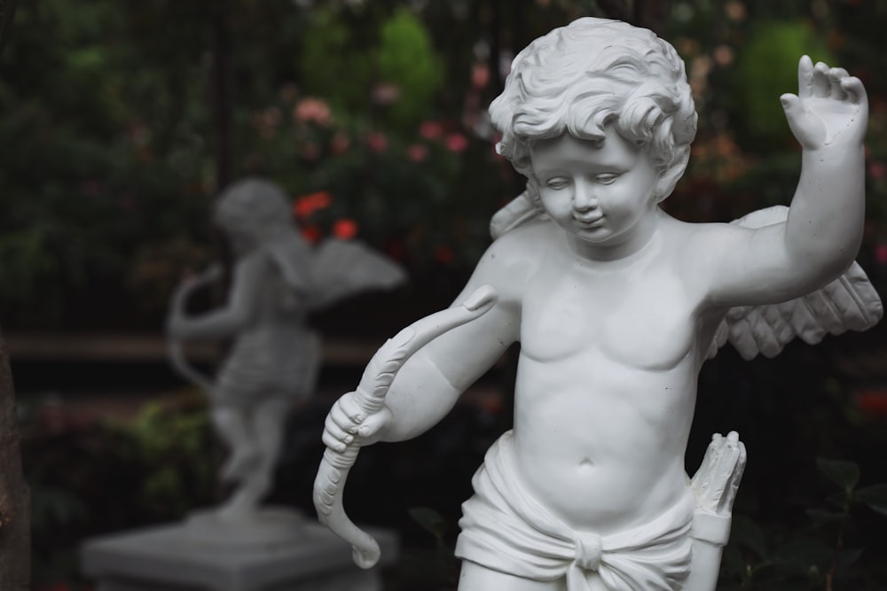 white ceramic statue of a topless woman