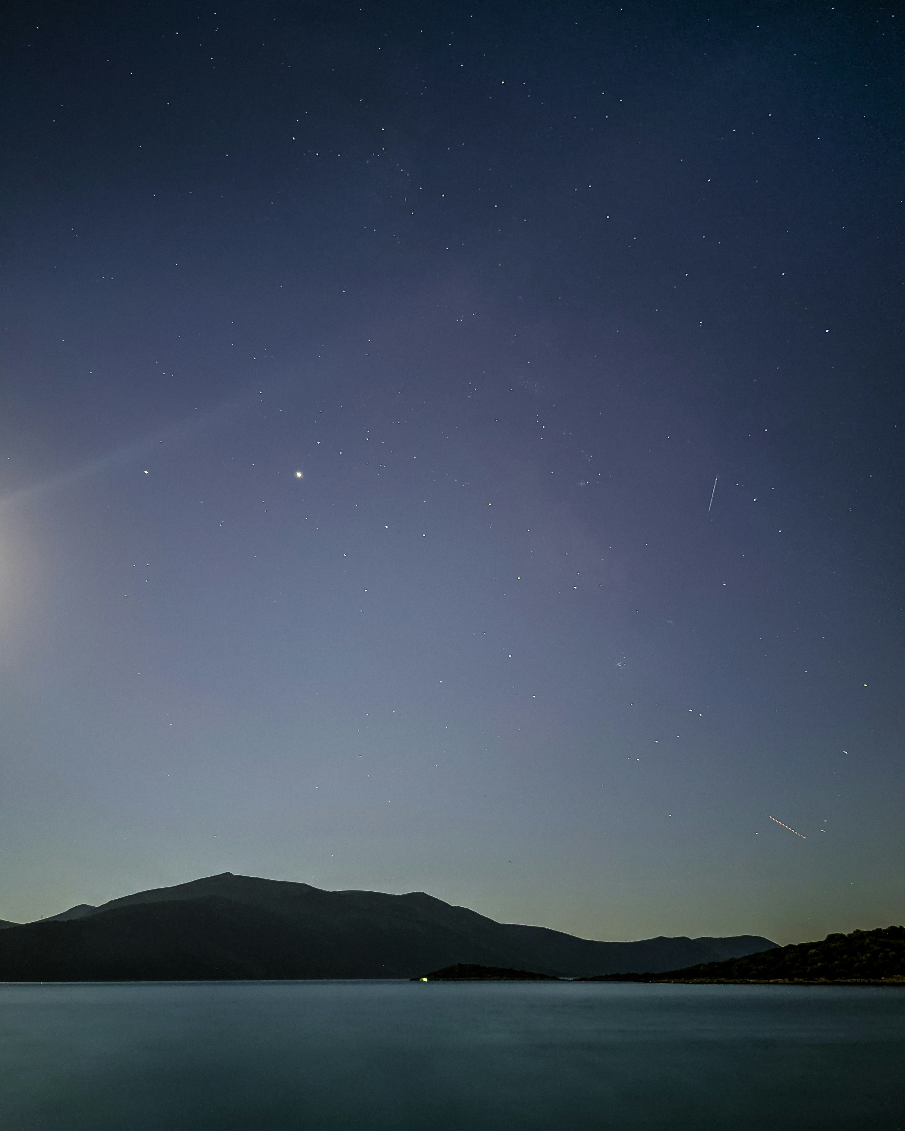 silhouette of mountain under starry night
