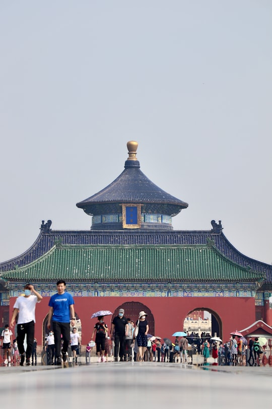 people standing near green and brown building during daytime in Temple of Heaven China