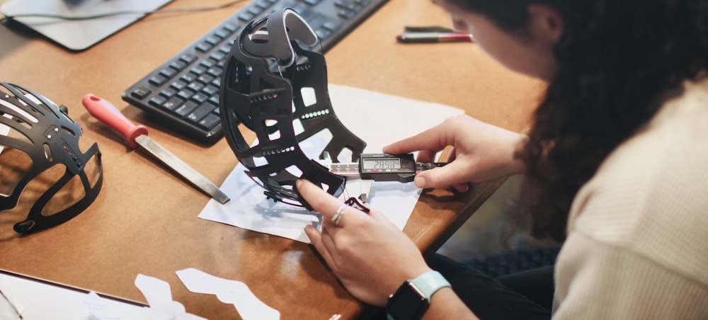 person holding black and white star wars r 2 d 2 toy