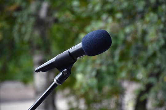 A microphone surrounded by nature-themed icons symbolizing environmental discussions.