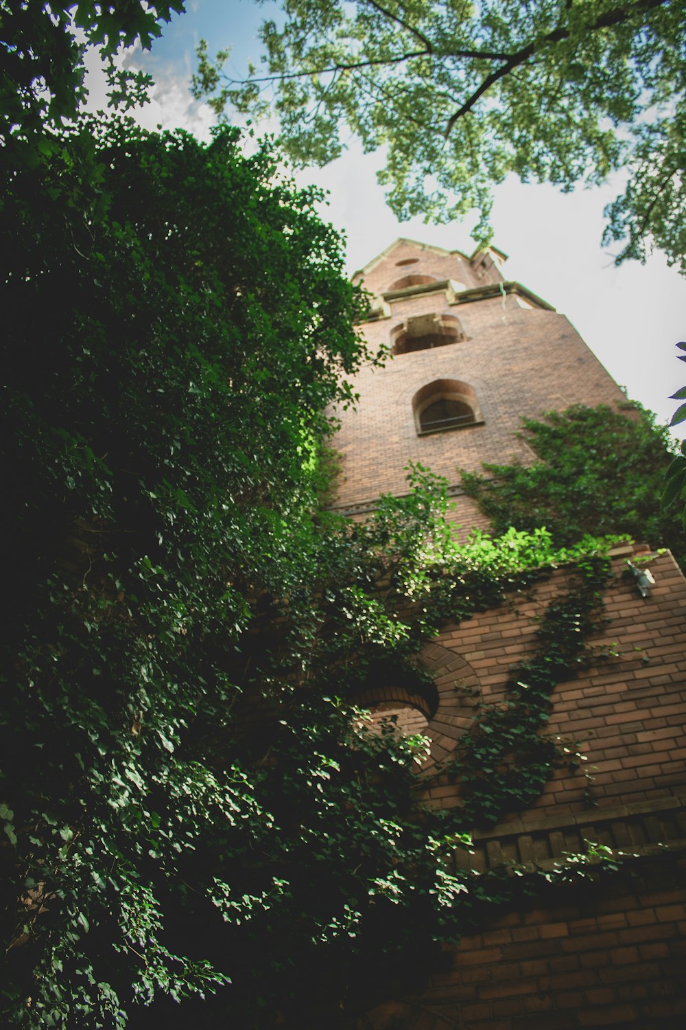 brown brick building near green trees during daytime