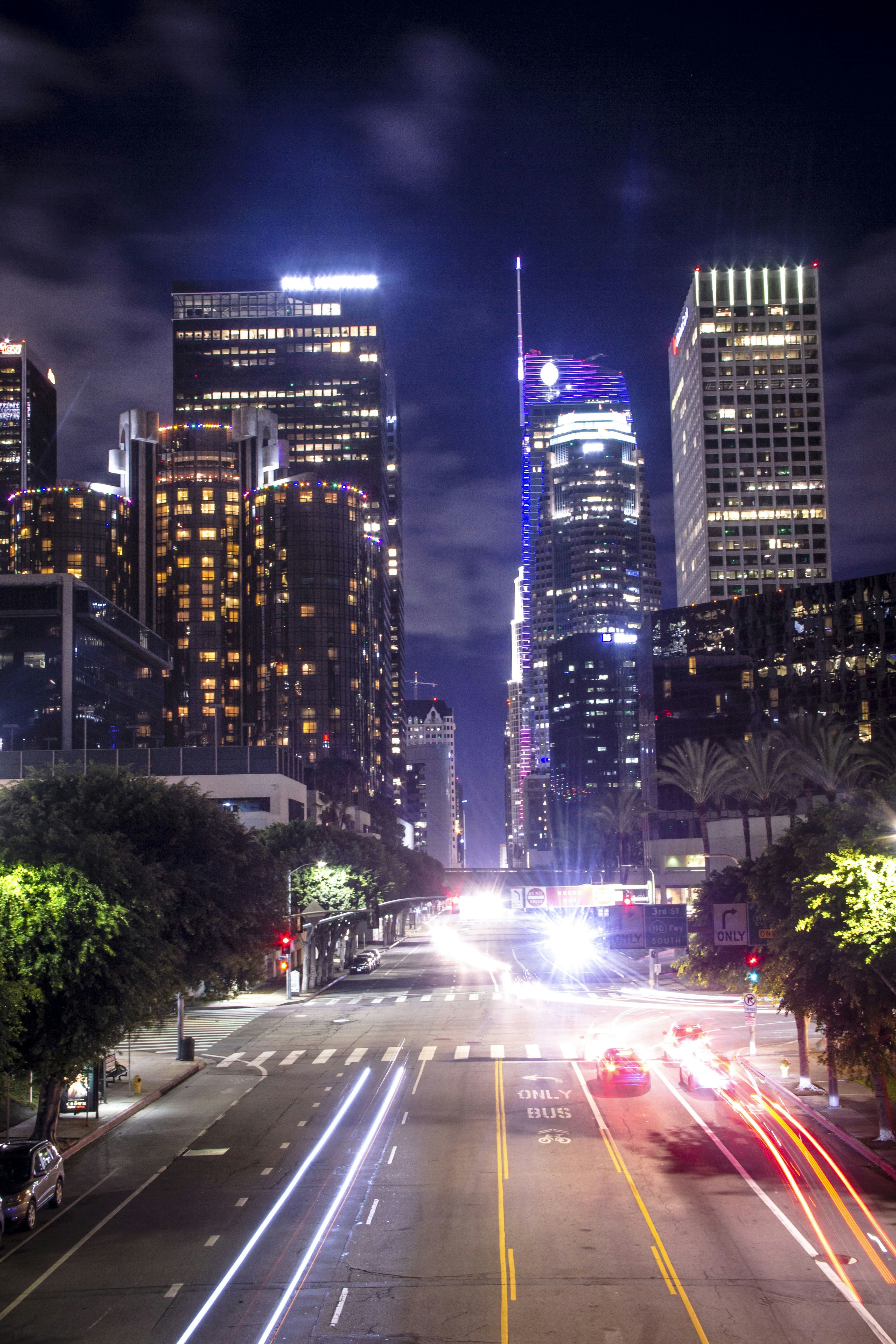 city buildings with lights turned on during night time