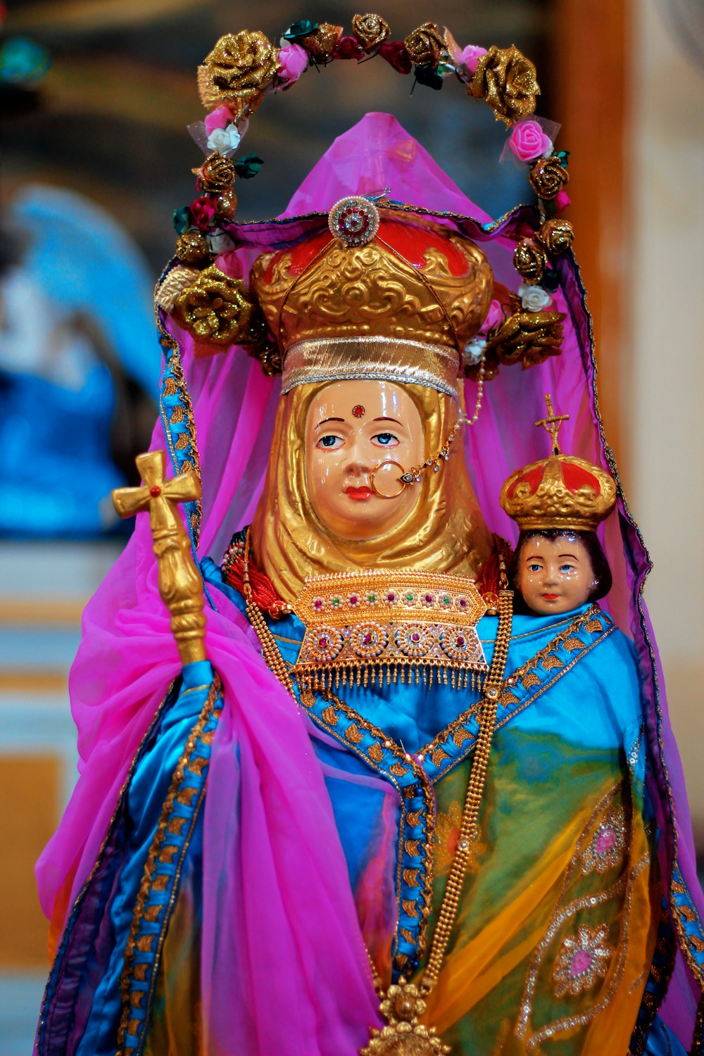 woman in blue and pink dress wearing gold crown