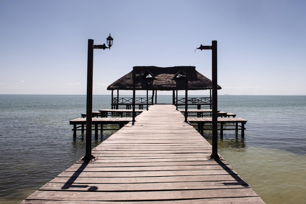 brown wooden dock on blue sea under blue sky during daytime