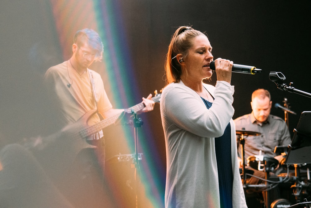 woman in white long sleeve shirt singing