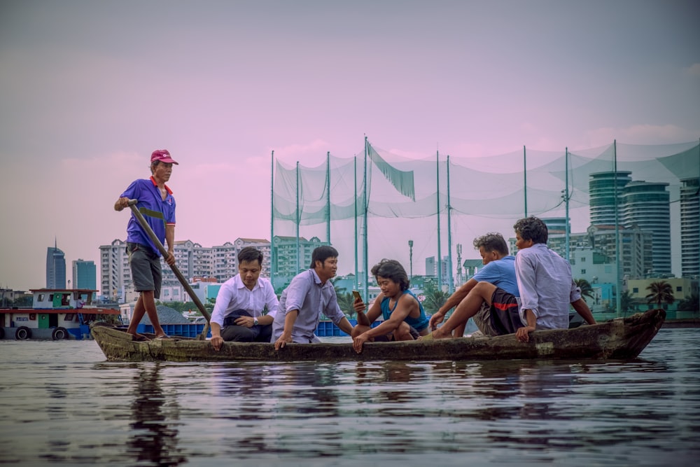 people sitting on brown wooden dock during daytime