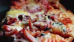 A close-up of a freshly baked pizza with melted cheese and vibrant toppings.