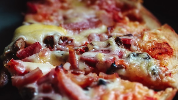 A close-up of a freshly baked pizza with melted cheese and vibrant toppings.