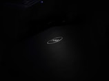A dark image with a Dell laptop logo centrally placed, featuring a softly illuminated keyboard in the top left corner.
