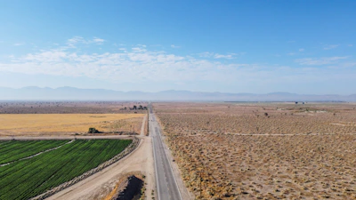 brown dirt road under blue sky during daytime