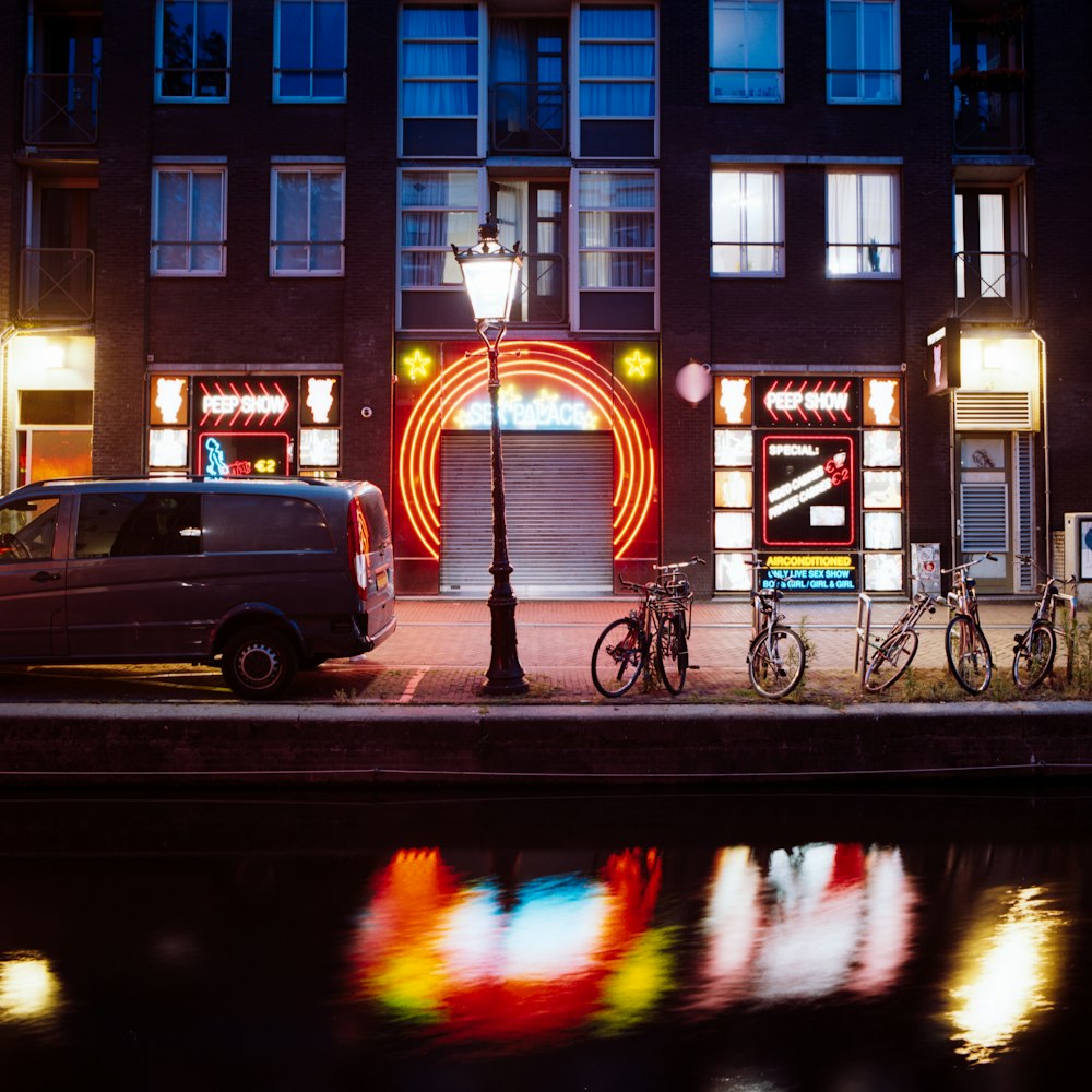 man in black jacket riding bicycle on road during night time