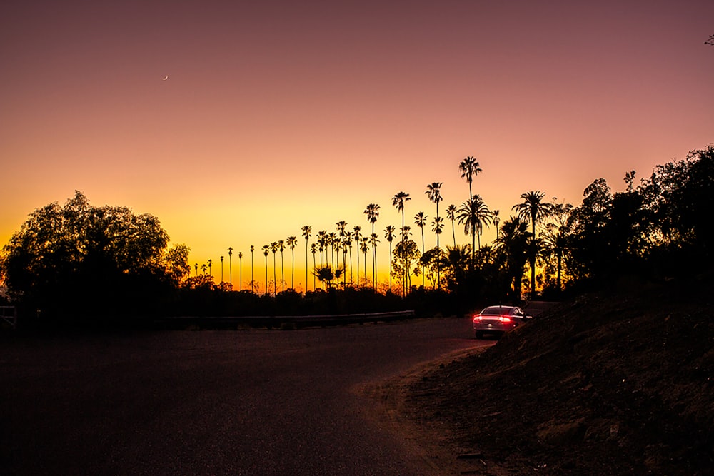 red car on road during sunset