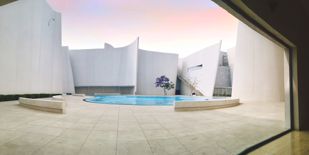 white concrete building with swimming pool