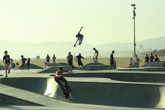 Ricardo Pastor filming a gritty, high-energy action sports video on a sunny Southern California beach.