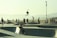 A group of skaters performing tricks at a vibrant skate park.