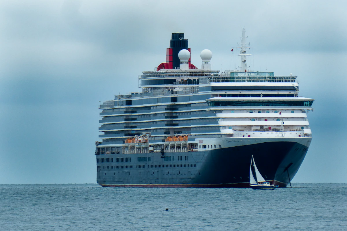 Cunard ocean liner at sea under a cloudy sky
