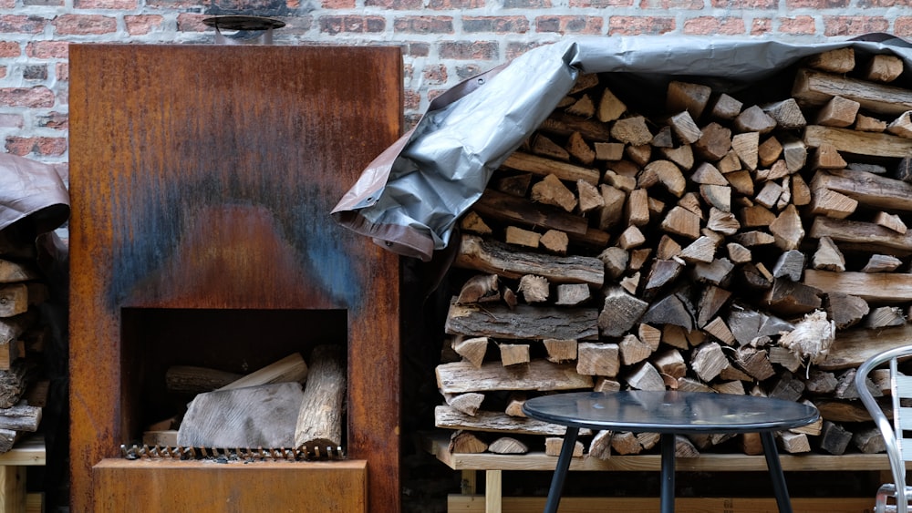 brown firewood on black metal rack