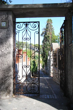 A charming garden gate partially open, inviting visitors inside.