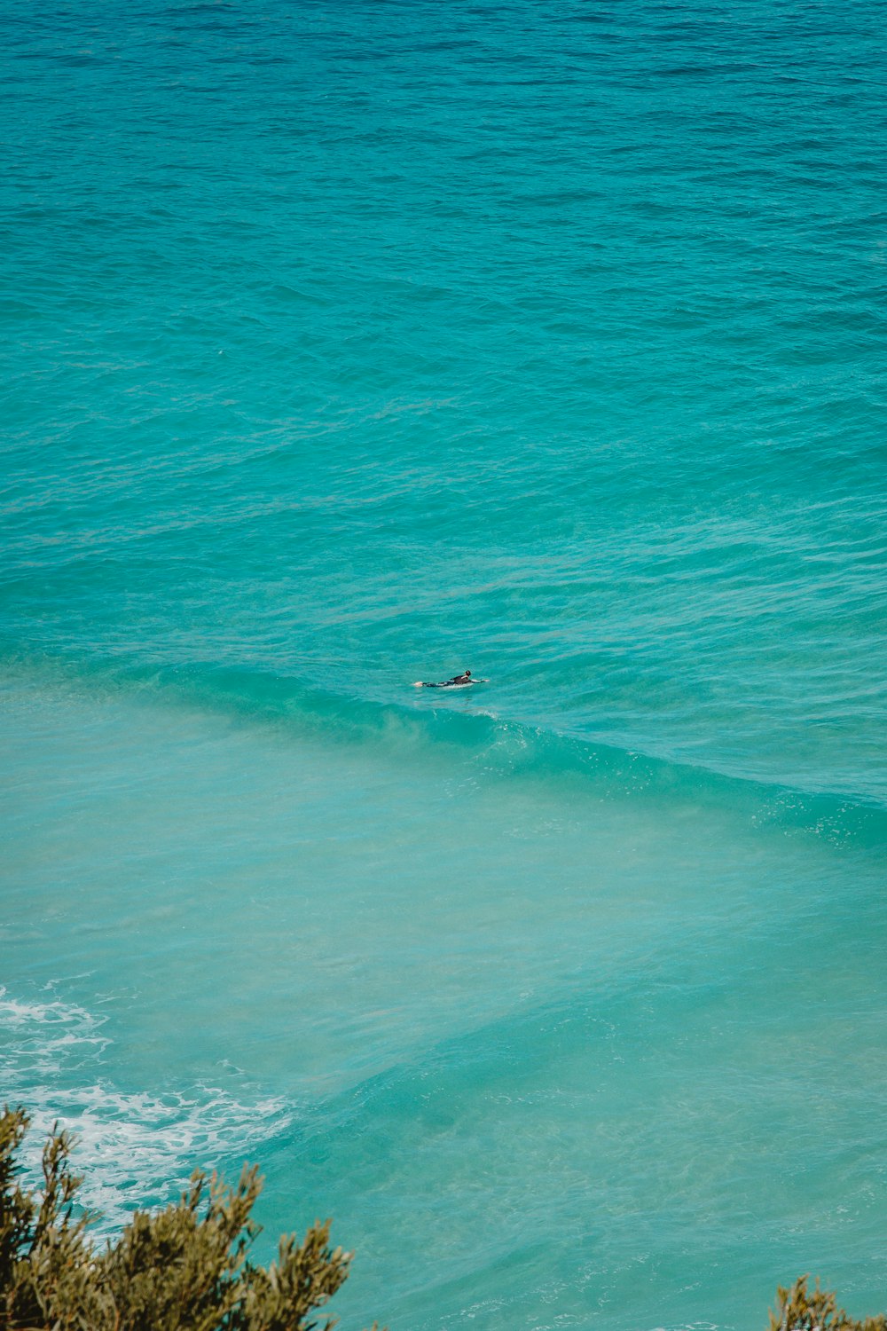 person surfing on sea waves during daytime