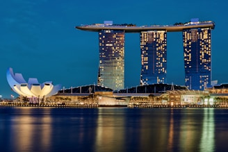 white and blue building near body of water during daytime