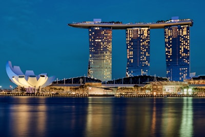 white and blue building near body of water during daytime