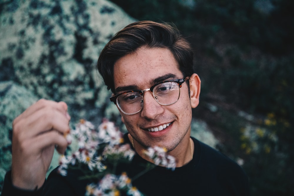 man in black crew neck shirt wearing black framed eyeglasses