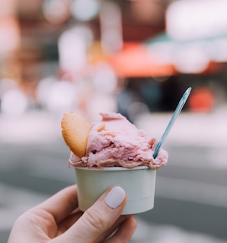 person holding ice cream cone with ice cream