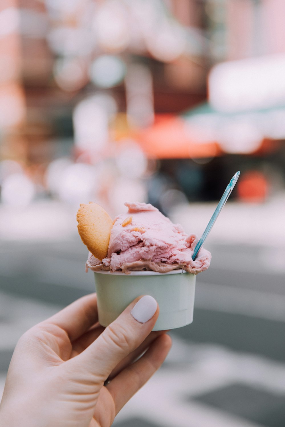 person holding ice cream cone with ice cream