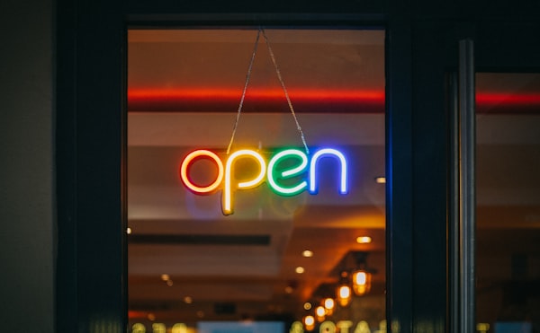 Coloured neon sign saying 'Open'