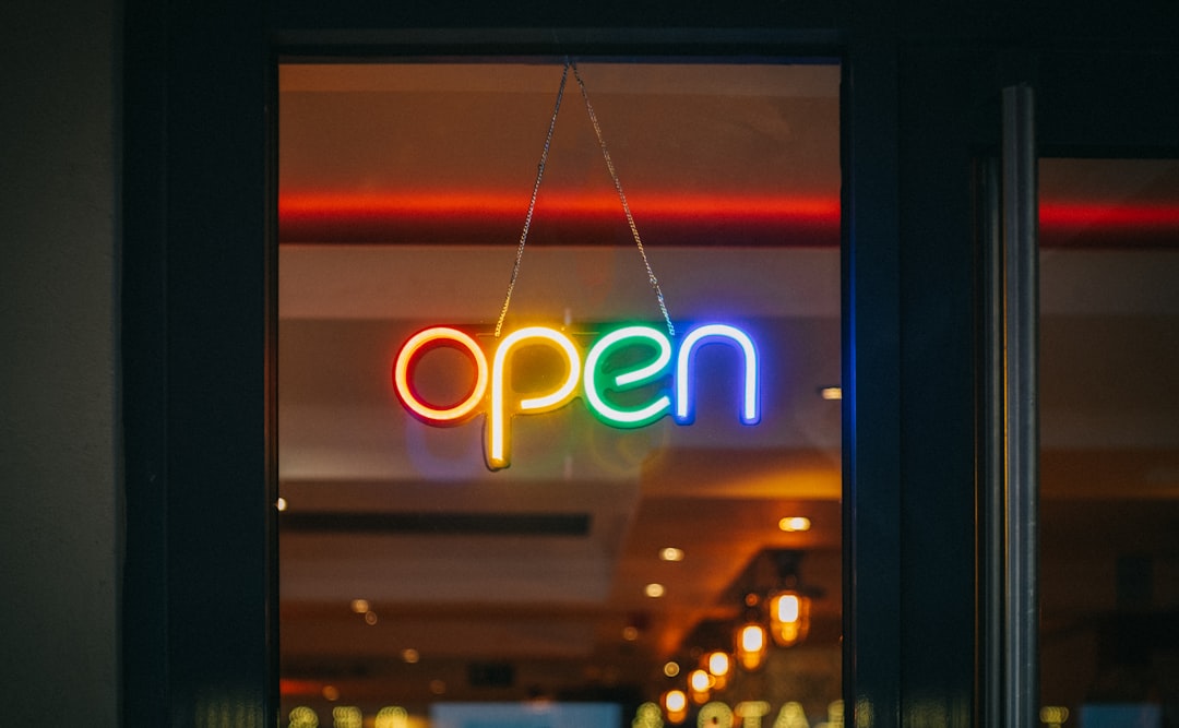 red and white open neon signage,