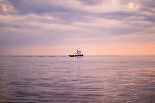 white and black boat on sea under white clouds during daytime in Varberg Sweden