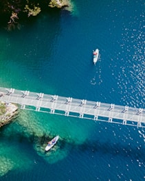 aerial view of white and red boat on blue sea during daytime