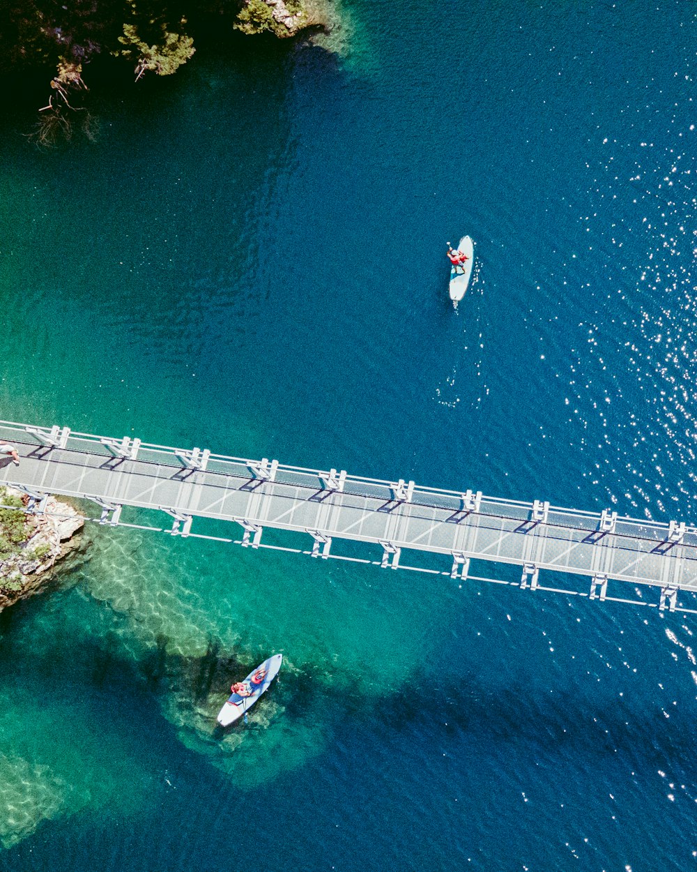 aerial view of white and red boat on blue sea during daytime