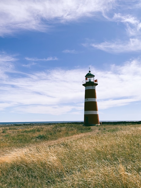 black and white lighthouse under blue sky