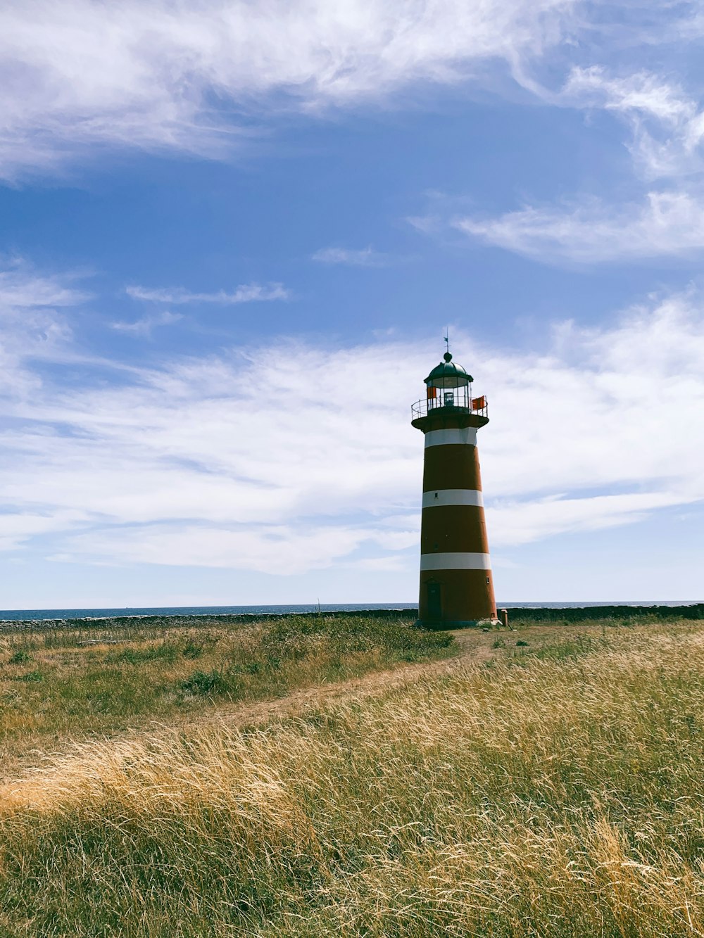 black and white lighthouse under blue sky