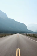 Freshly paved highway stretching into the horizon under a clear sky.