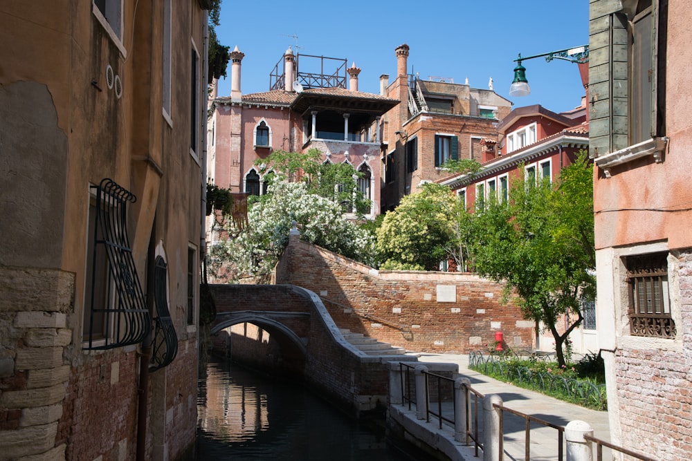 brown concrete building beside river during daytime