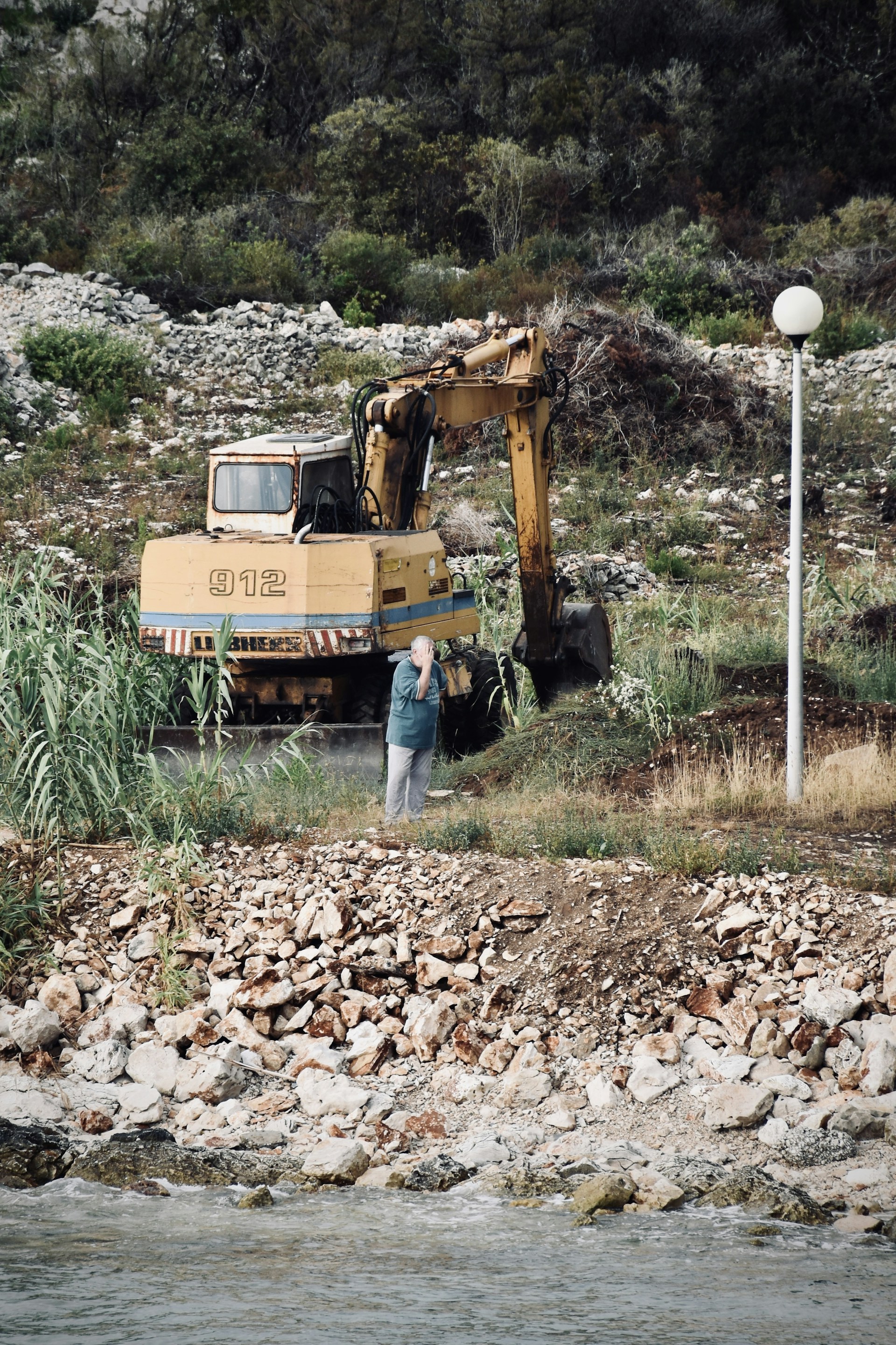 yellow and black excavator on brown dried leaves during daytime