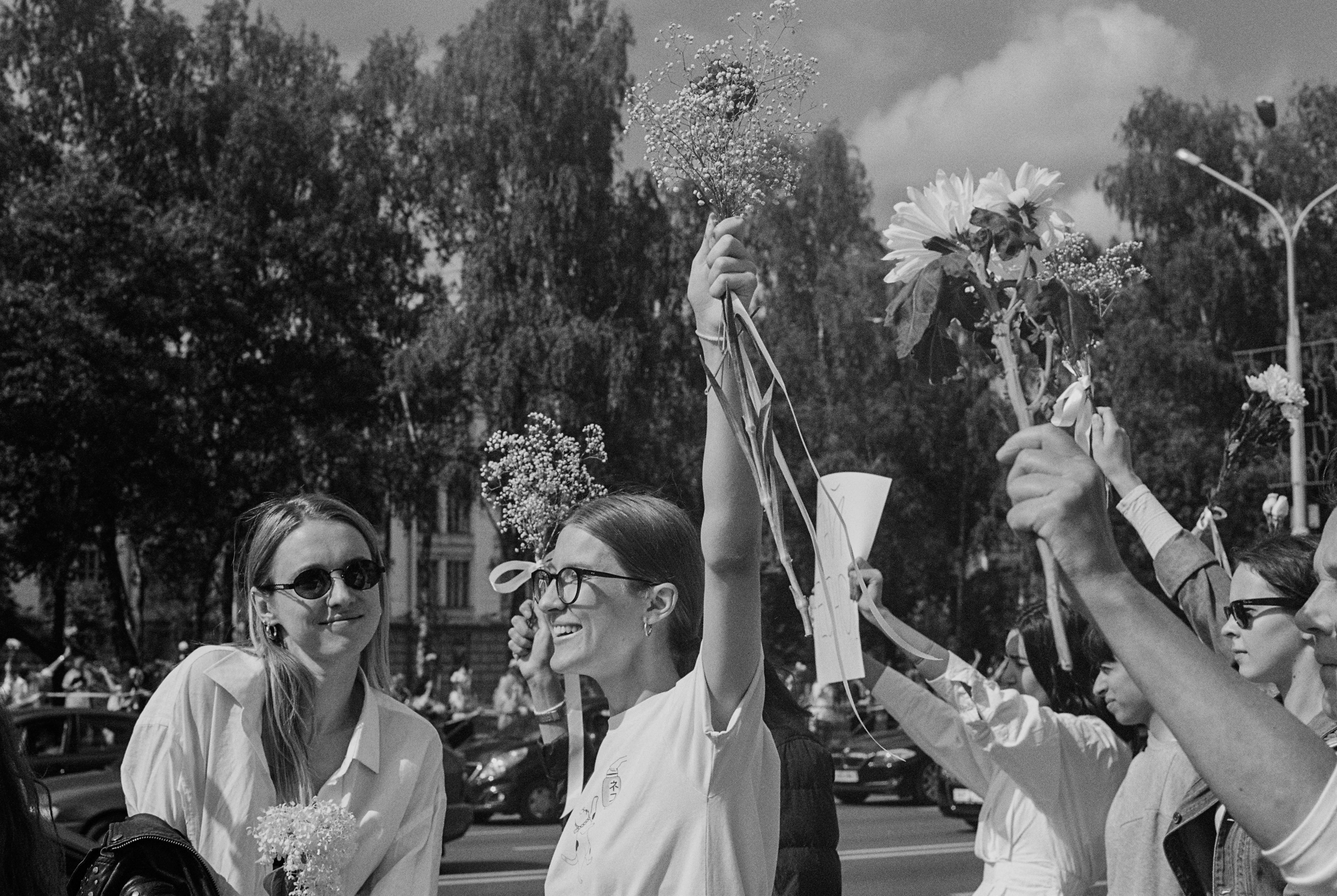 grayscale photo of man and woman holding umbrella belarus teams background