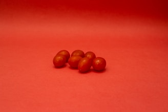 brown round fruits on red textile