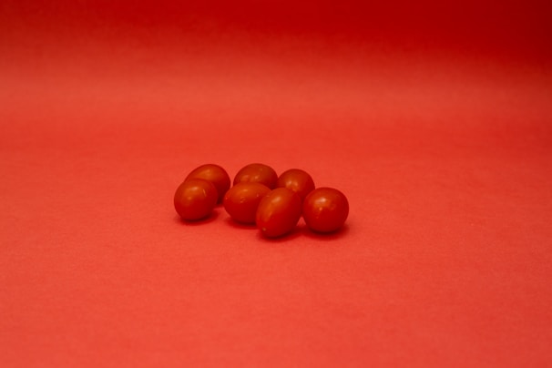 brown round fruits on red textile