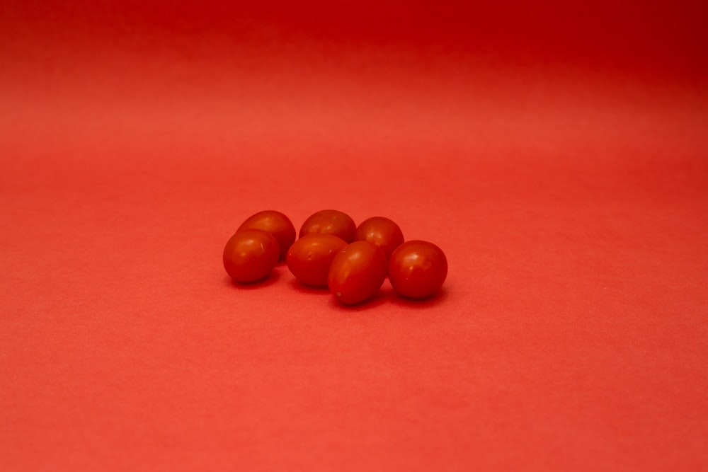 brown round fruits on red textile