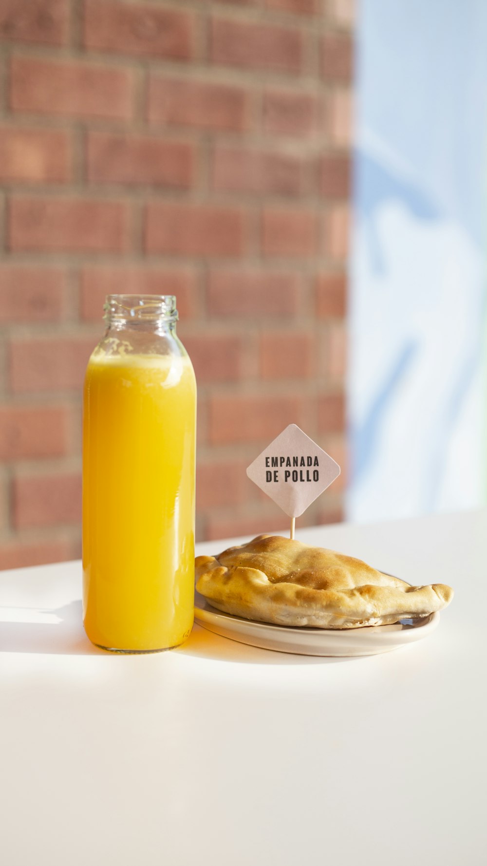 clear glass bottle with yellow liquid inside