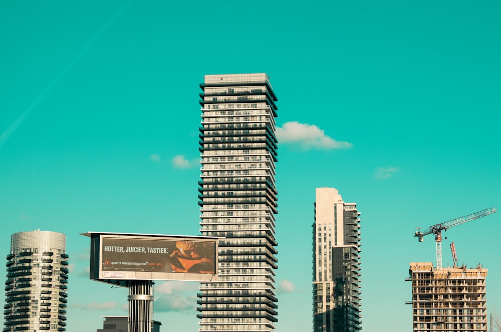 white and black high rise buildings under blue sky during daytime